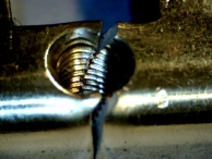 A euro-profile cylinder that has been broken at the central weak point, near the set screw.