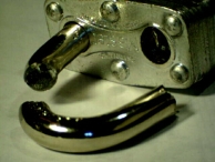 The shackle of a padlock that has broken at two separate points.