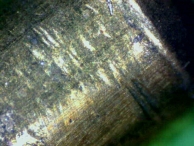 Impressioned pin-tumbler pin with shearing so visible that it is possible to count the number of impressions taken.