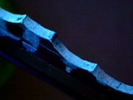 A key that has ultraviolet ink residue along the key bitting. Indicative of impressioning via manipulation.