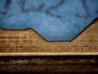 A factory original key. Notice the flat valleys and properly angled slopes.