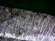The bitting of a key that has been filed with a flat, wide file of medium grade.
