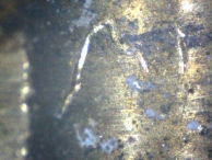 A tool mark from a lockpicking tool found in the chamber of a pin-tumbler lock.