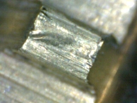 A gouge created by a picking tool found along the warding inside of the plug.